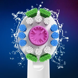 Oral-B brush head with green, white, and blue bristles, surrounded by a splash of water.