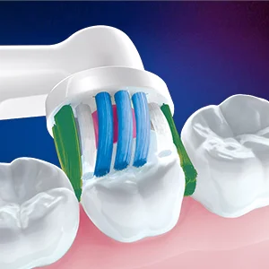 Oral-B toothbrush head demonstrating cleaning action on teeth with multi-colored bristles.