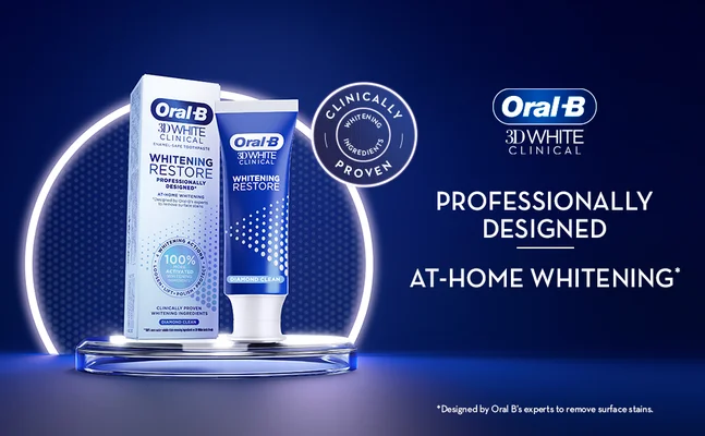 An Oral-B 3D White Clinical Whitening Restore toothpaste box and tube are shown on a platform with text Oral-B 3D WHITE CLINICAL PROFESSIONALLY DESIGNED AT-HOME WHITENING* CLINICALLY WHITENING INGREDIENTS PROVEN 100% ACTIVATED WHITENING INGREDIENTS CLINICALLY PROVEN WHITENING INGREDIENTS DIAMOND CLEAN *Designed by Oral Bs experts to remove surface stains.