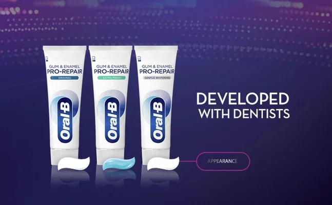 Three tubes of Oral-B Gum & Enamel Pro-Repair toothpaste in Original, Extra Fresh, and Gentle Whitening varieties with dispensed toothpaste in front, against a purple background with text reading DEVELOPED WITH DENTISTS and APPEARANCE.