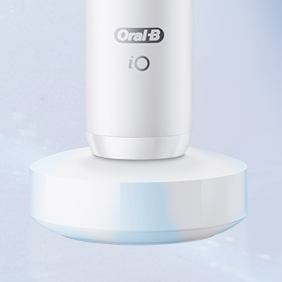 Oral-B iO electric toothbrush on its charging base.