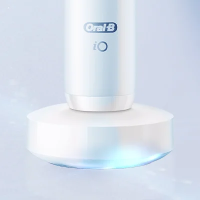 Oral-B iO toothbrush charging on its magnetic base.
