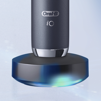 Oral-B iO electric toothbrush on its magnetic charger, showing the sleek design.