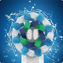 An Oral-B toothbrush head with blue, green, and white bristles is shown with water splashing around it.