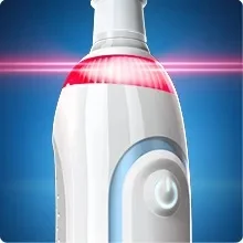 Close-up of a white electric toothbrush handle with an illuminated red pressure sensor light, power button, and blue light strip.