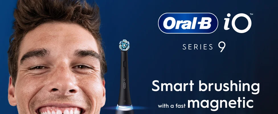 An Oral-B iO Series 9 electric toothbrush with a man smiling on the left