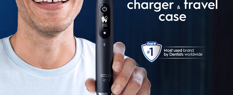 A hand holding a black Oral-B iO9 toothbrush with a no.1 dentist claim