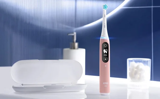 Oral-B iO toothbrush in pink, displaying the