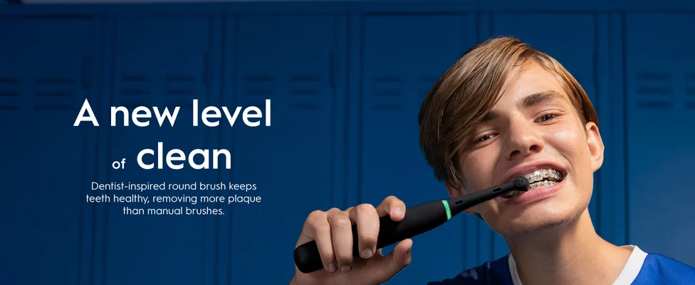 Person with an electric toothbrush. "A new level of clean" claim showing dental benefits