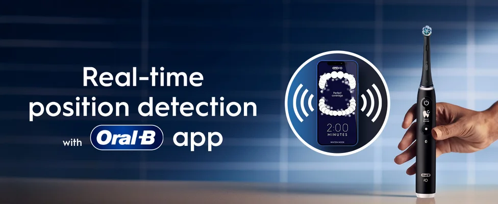 An Oral-B toothbrush with a close-up on the app showing real-time brushing tracking technology