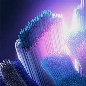Oral-B abstract image of toothbrush bristles illuminated in blue and purple light.