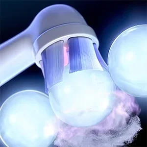 Oral-B toothbrush head with bristles surrounded by illuminated bubbles, highlighting cleaning action.