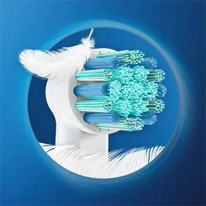 Oral-B toothbrush head close-up with a feather, highlighting the gentle cleaning power of the bristles.