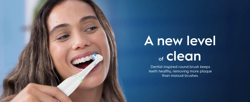 Person using electric toothbrush with text about dentist-inspired round brush for better cleaning