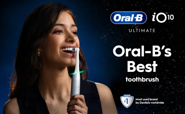 Smiling women brushing her teeth with oral-b iO Series 10