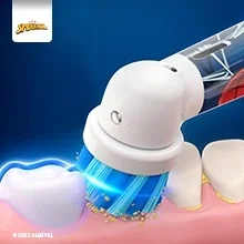 Oral-B toothbrush with Spider-Man design cleaning teeth, with blue light effect highlighting the cleaning action.