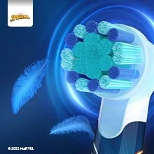 Oral-B toothbrush head close-up, highlighting the soft bristles and gentle cleaning power, with floating feathers to emphasize the softness.