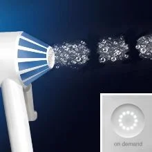 A white device nozzle emits a stream of bubbles and an inset shows a button with lights and the text on demand.