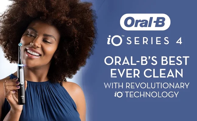 A woman smiles while holding an Oral-B electric toothbrush with a blue light, Oral-B iO SERIES 4 ORAL-BS BEST EVER CLEAN WITH REVOLUTIONARY iO TECHNOLOGY.
