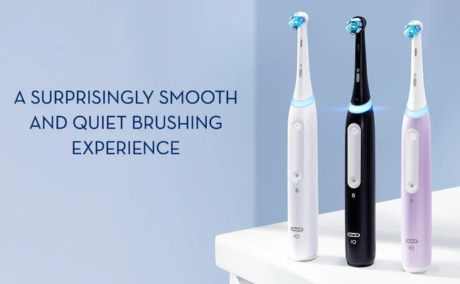 Three Oral-B iO electric toothbrushes in white black and purple on a white surface against a blue background with the text A SURPRISINGLY SMOOTH AND QUIET BRUSHING EXPERIENCE.