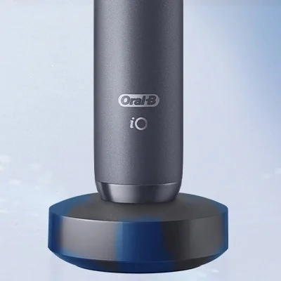 Oral-B iO toothbrush charging on its magnetic charging base.