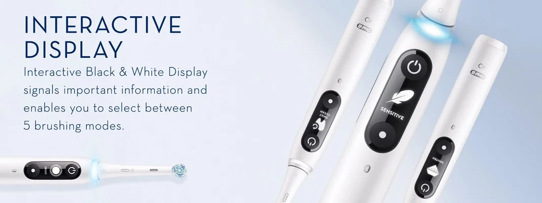 A close-up of several white Oral-B electric toothbrushes with interactive displays and text reading INTERACTIVE DISPLAY Interactive Black & White Display signals important information and enables you to select between 5 brushing modes. DAILY CLEAN SENSITIVE WHITEN HELLO.