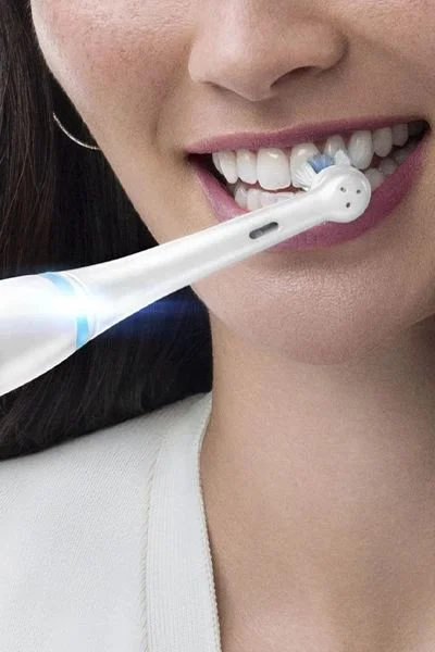 Oral-B electric toothbrush in use, demonstrating how it cleans teeth.