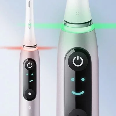 Oral-B iO toothbrush featuring a digital display with a smiley face and colored light ring.