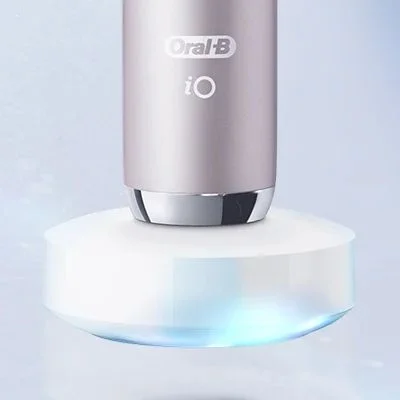Oral-B iO toothbrush in its charging base, showing the product's sleek design.