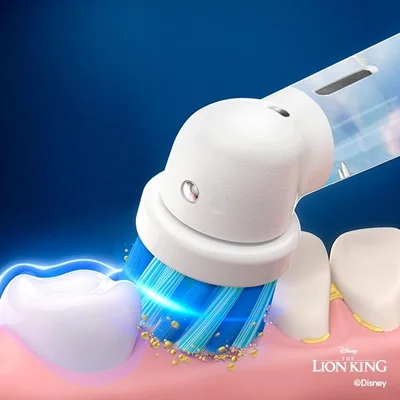 Oral-B toothbrush head cleaning teeth, removing plaque, with a