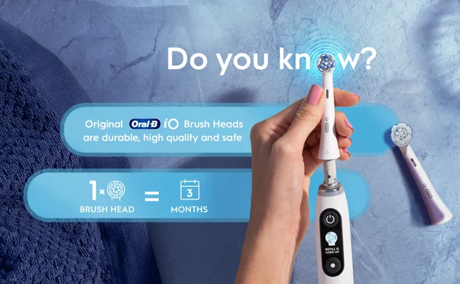 Hand holds Oral-B iO brush head that lasts for 3 months, making it less than 4 € a month.