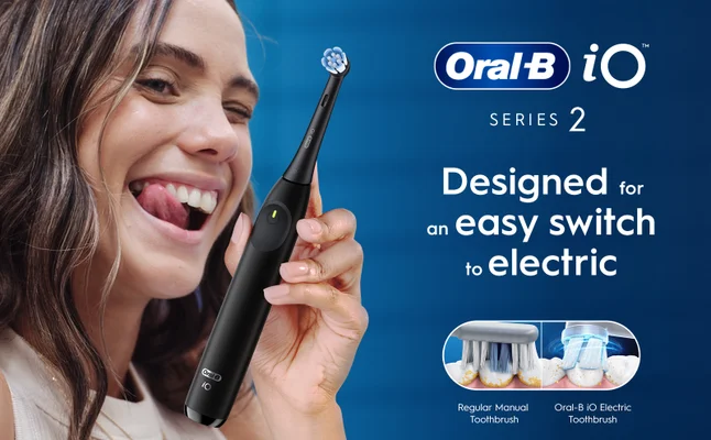 Close-up of a woman with an Oral-B iO Series 2 electric toothbrush, designed for an easy switch to electric.
