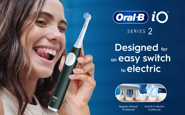 Close-up of a woman with an Oral-B iO Series 2 electric toothbrush, designed for an easy switch to electric.