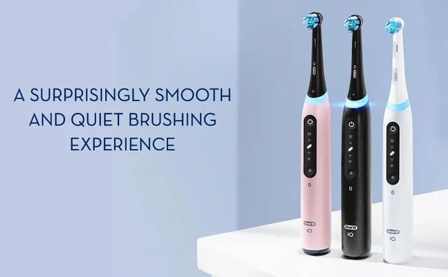Three electric toothbrushes in pink, black, and white are displayed on a surface against a light blue background, with the text A surprisingly smooth and quiet brushing experience prominently featured.