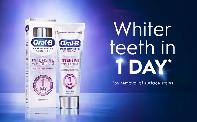 A tube of Oral-B Pro-3D White Clinical toothpaste is shown next to its box, with text stating Whiter teeth in 1 DAY* and by removal of surface stains along with Intensive Whitening and Radiant White.