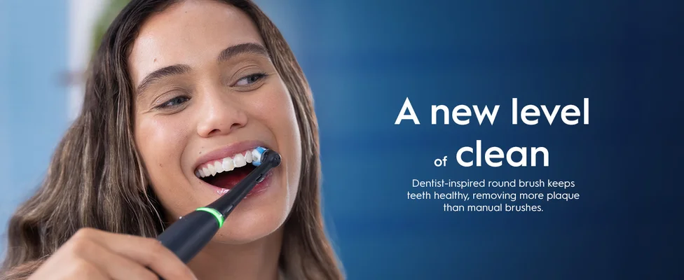 Person using electric toothbrush with text about dentist-inspired round brush for better cleaning