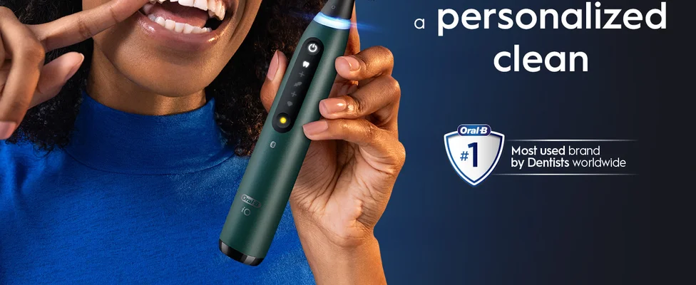 Smiling person with Oral-B toothbrush featuring