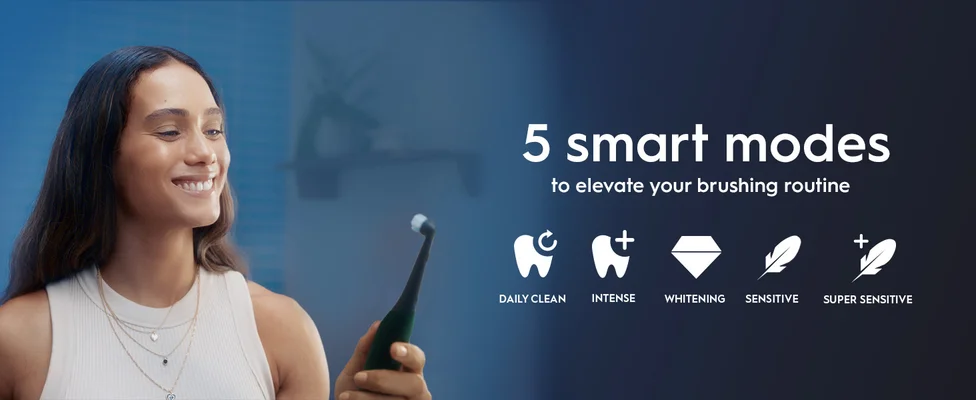 Person holding electric toothbrush with 5 smart modes: Daily Clean, Intense, Whitening, Sensitive, Super Sensitive.