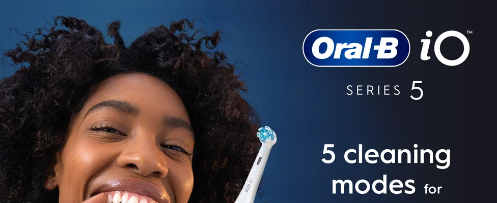 Close-up of a person smiling and holding an Oral-B iO toothbrush with the text Oral-B iO SERIES 5 5 cleaning modes for.