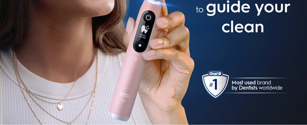 A hand holding an Oral-B toothbrush with a claim 'To guide your clean, #1 dentist-recommended brand