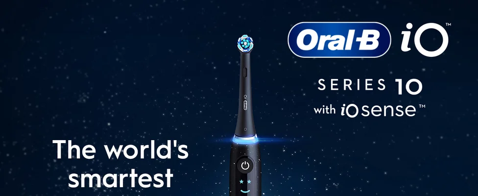 Oral-B iO Series 10 electric toothbrush with illuminated features on dark blue background.