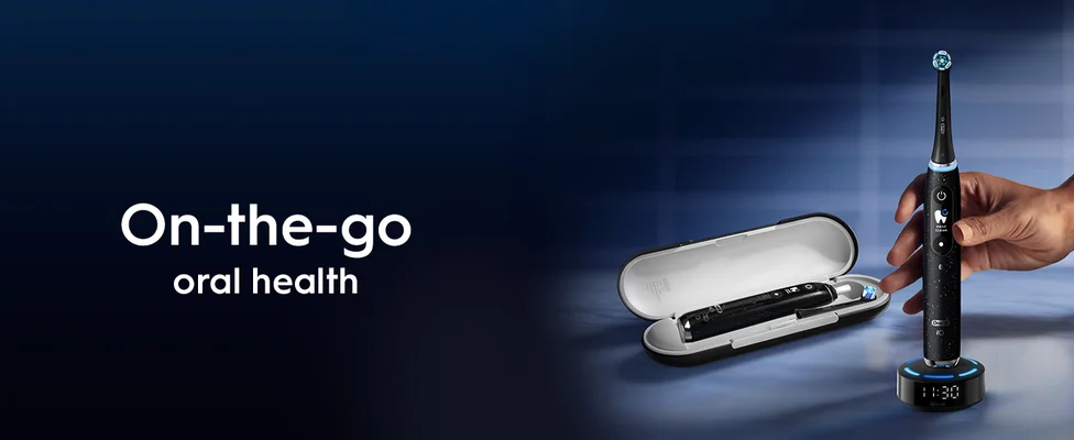 Electric toothbrush with travel case and charging base next to text