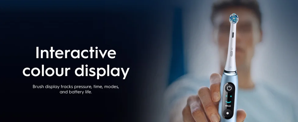 A person holds a blue electric toothbrush with a display showing a smiley face and HELLO, alongside text reading Interactive colour display, Brush display tracks pressure, time, modes, and battery life.