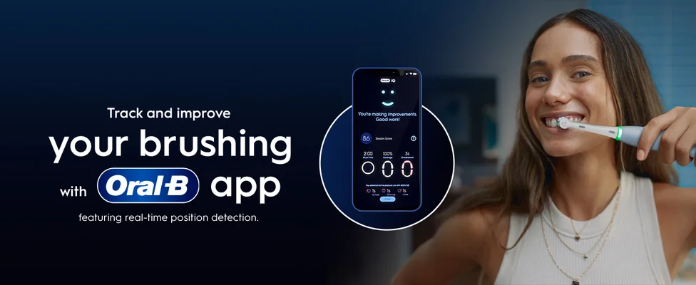 A woman brushes her teeth with an electric toothbrush as a phone displays the Oral-B app showing brushing statistics and the text Track and improve your brushing with Oral-B app featuring real-time position detection. Youre making improvements. Good work! 86 Session Score 2:00 Brush Time 100% Coverage 3s Overpressure Pay attention to the pressure you are applying! 1s Outside 1s Chewing 1s Inside DONE.