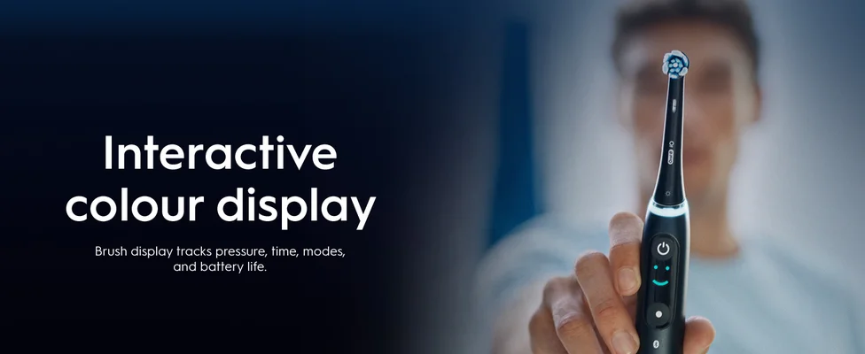 .A person holds the toothbrush in front of them showing the interactive colour display