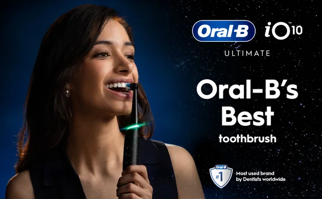 Smiling woman brushing her teeth with Oral-B iO Series 10.