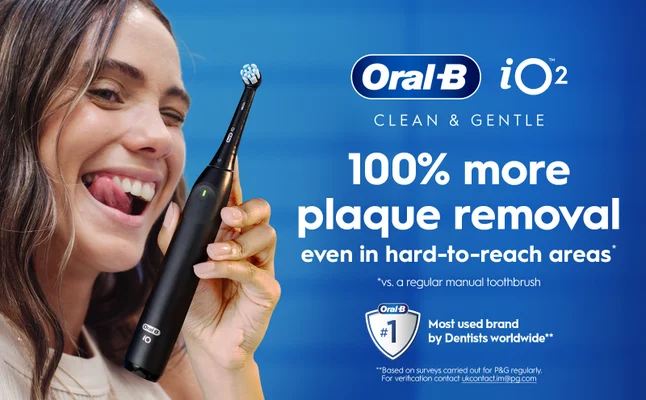 Oral-B iO2 toothbrush claiming 100% more plaque removal, shown with smiling person