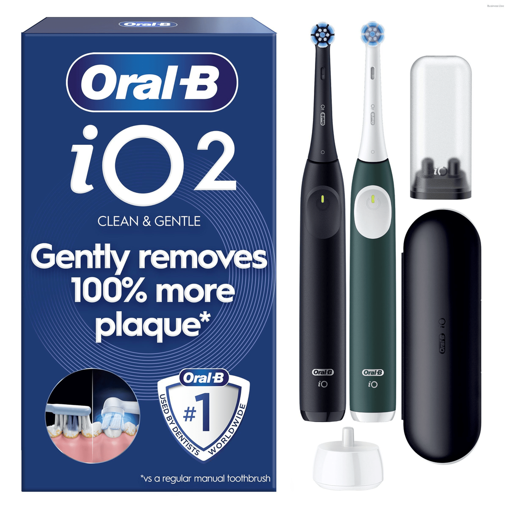 Oral-B iO2 electric toothbrushes (black and green) and packaging, highlighting 100% more plaque removal.