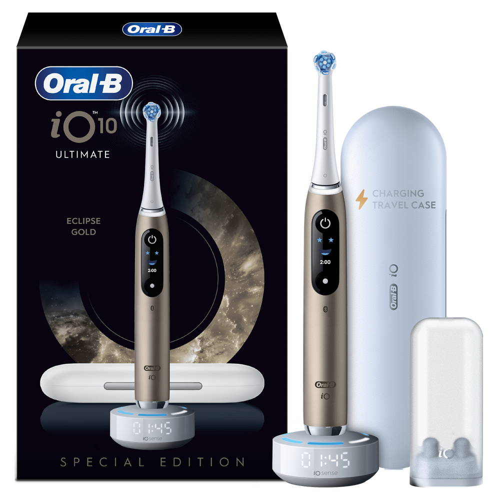 Oral-B iO 10 Ultimate Eclipse Gold toothbrush shown with charging base and charging travel case.