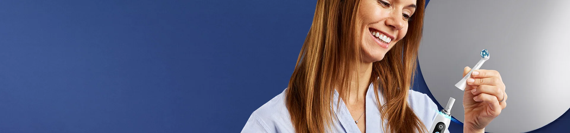 Woman holding Oral-B iO Electric Toothbrush